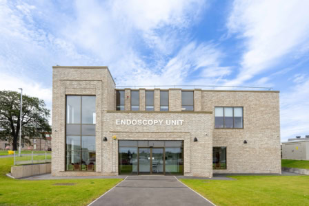 High-resolution photo of a contemporary endoscopy unit facility with clear sky.