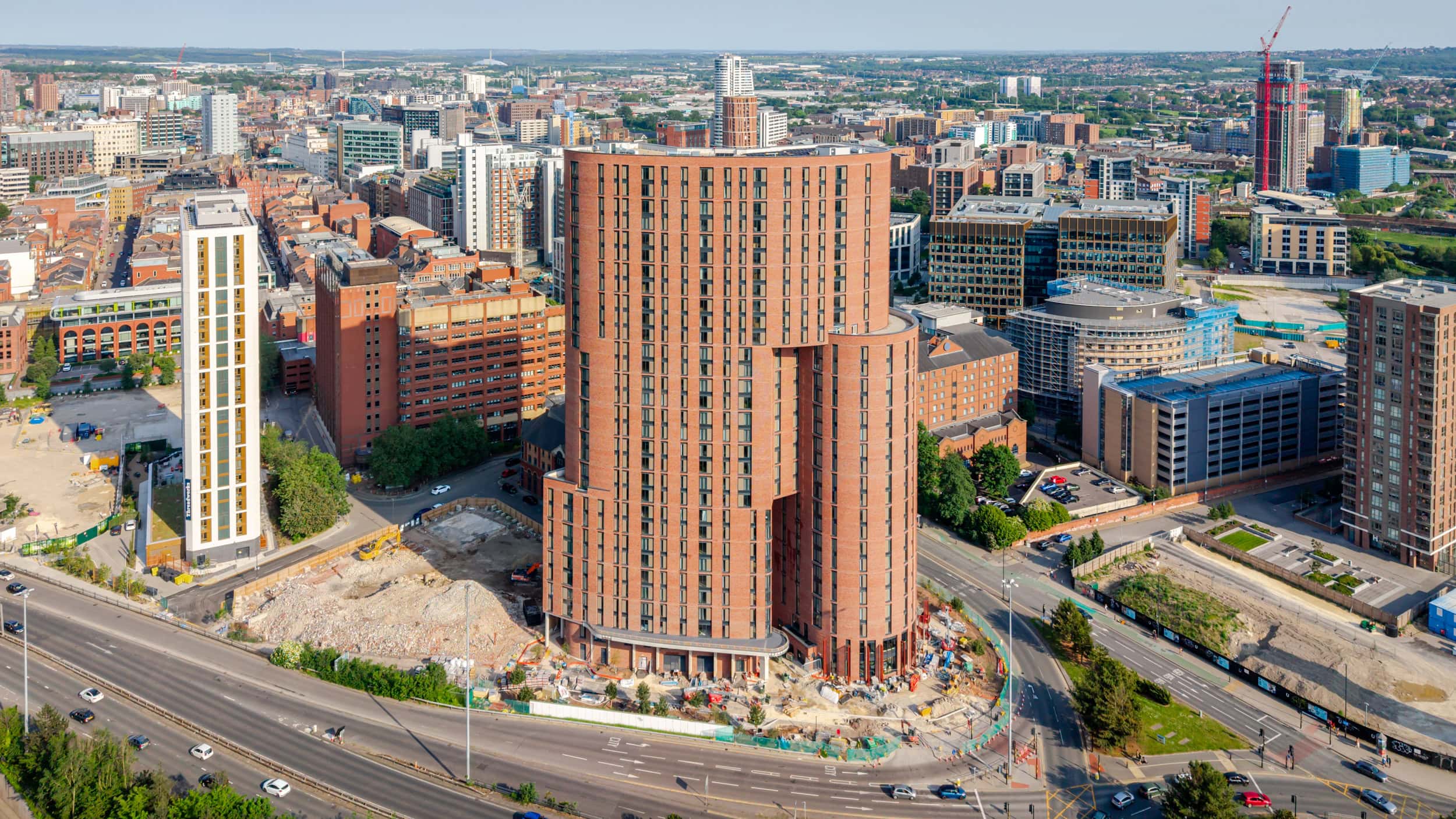 Modern high-rise building under construction in Manchester city center.