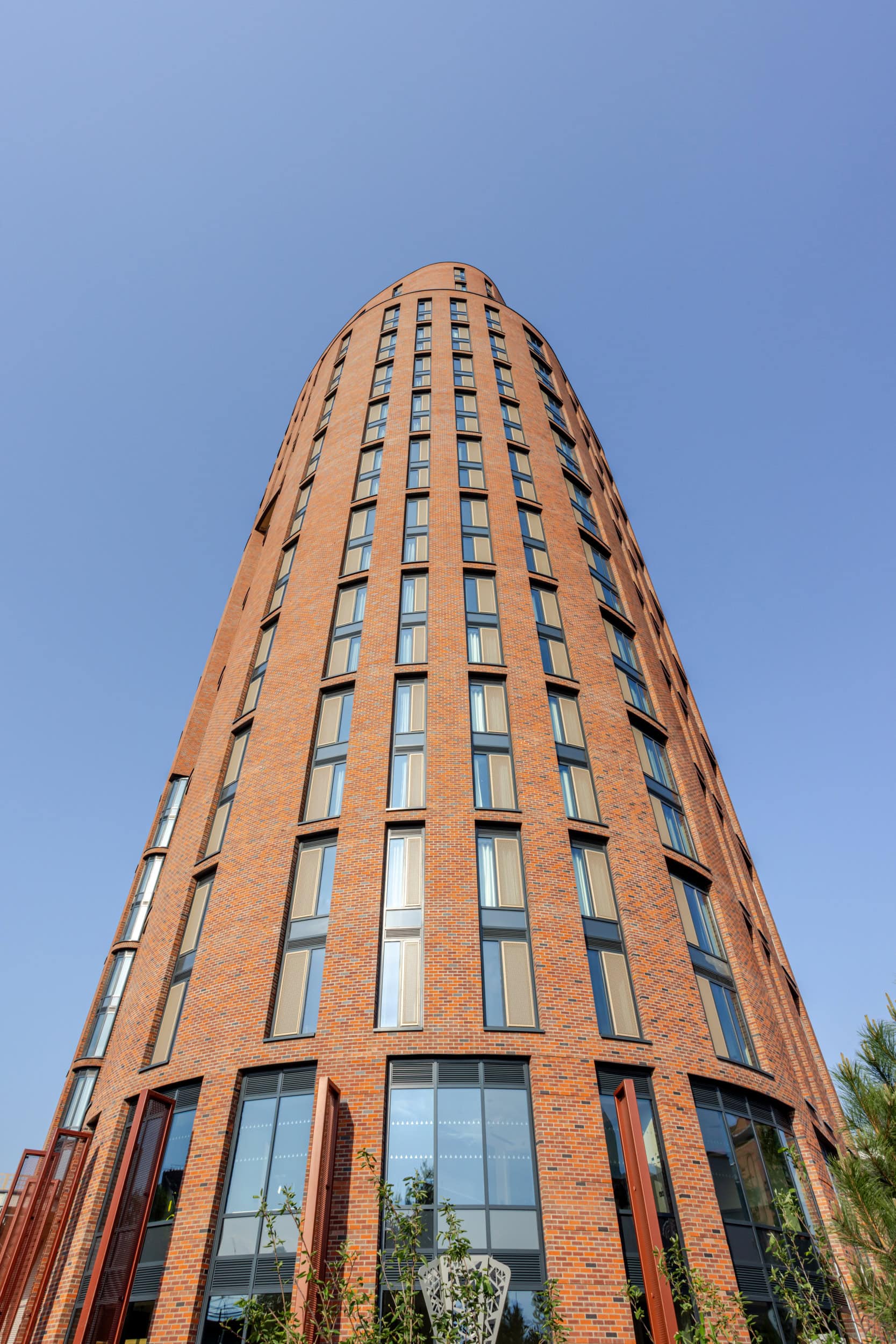 Modern brick high-rise building with tall windows on Skinner Street.