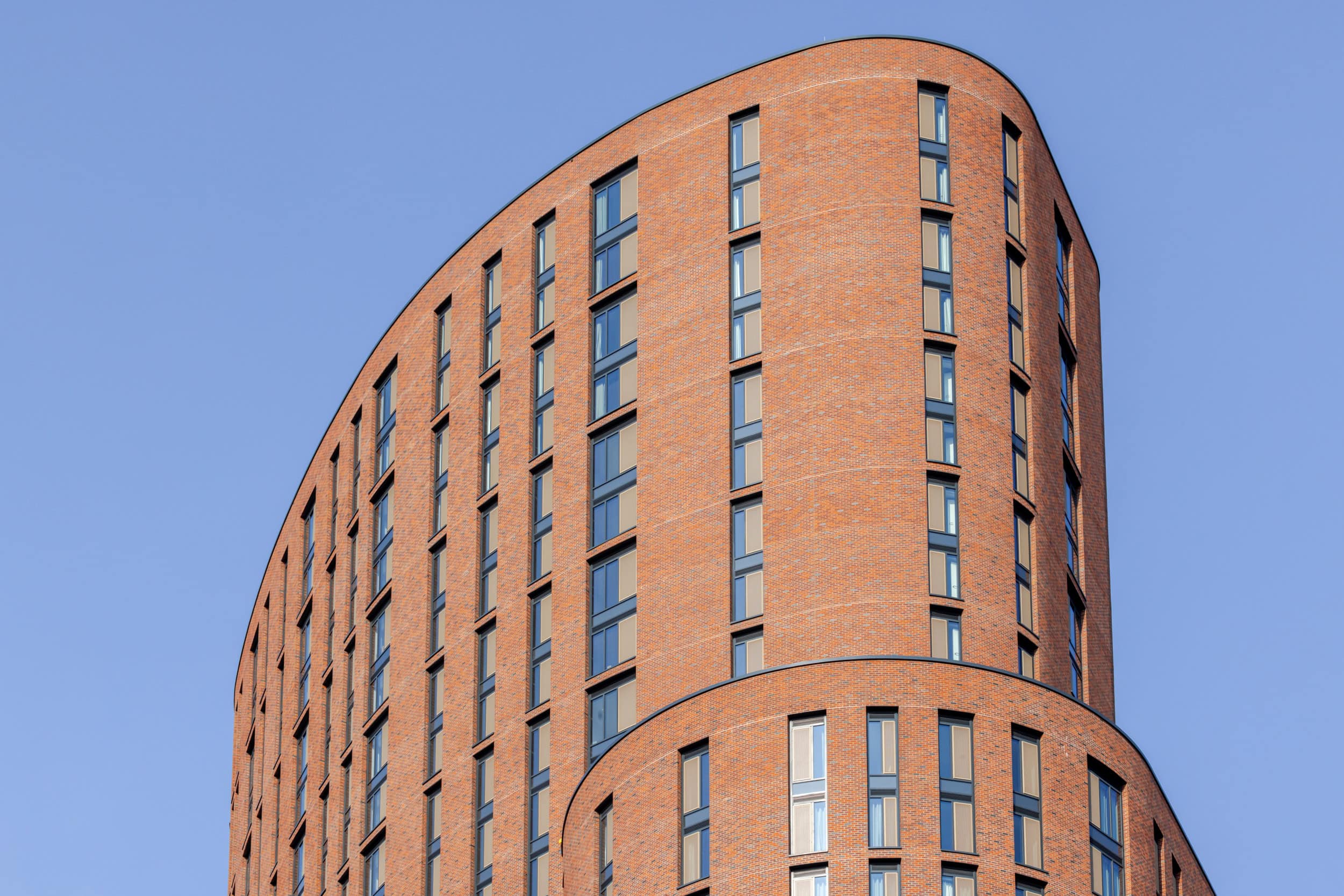 Contemporary brick building with curved design on Skinner Street.
