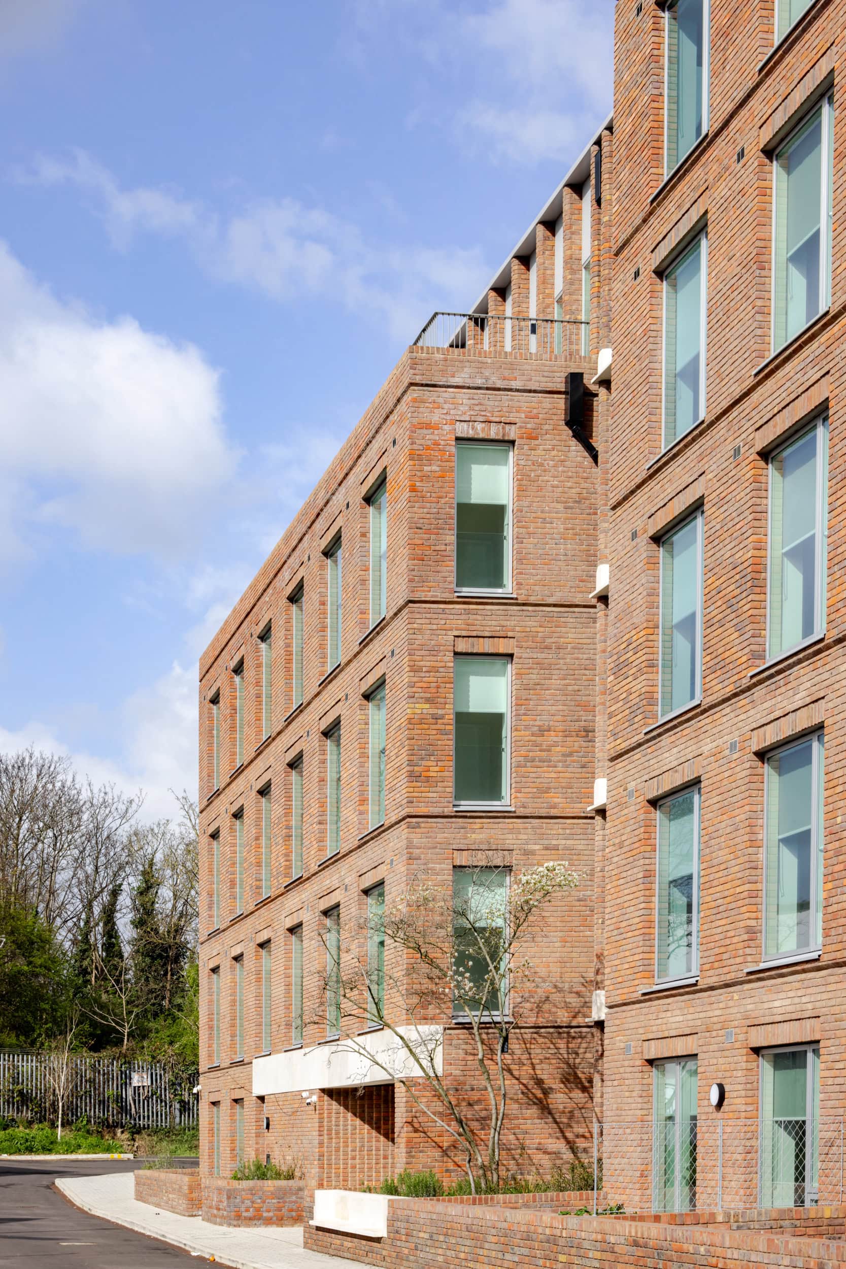 Contemporary brick building with large windows at The Heights development.